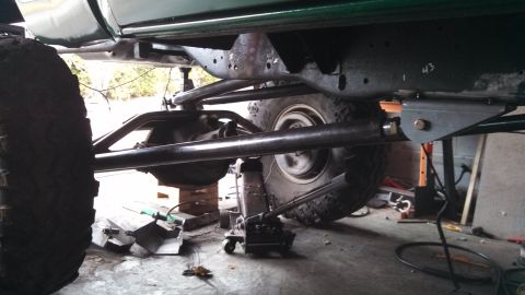 1967 Ford F-250 - Custom suspension work on a truck's undercarriage, with large tires and frame details visible.