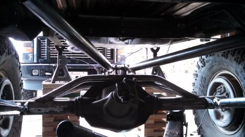 1967 Ford F-250 - Underside view of a modified Ford truck chassis, showing custom suspension and roll cage components.