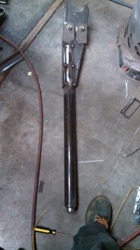 1967 Ford F-250 - Custom fabricated metal part, likely for a vehicle suspension system, on a workshop floor.