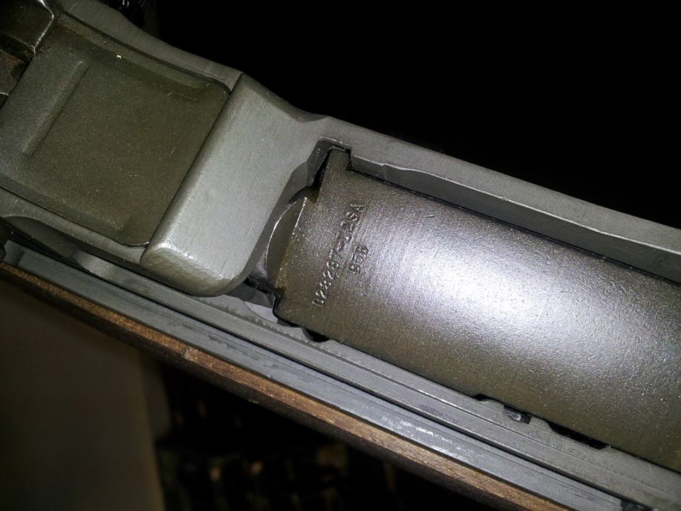 Close-up of parkerized firearm barrel and receiver with stamped U.S.A. markings