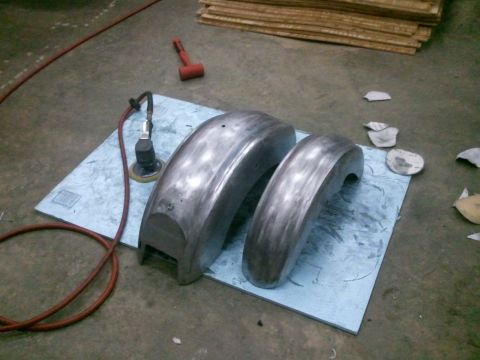 1995 Ford F-150 - Bare metal fenders are prepared for finishing with an orbital sander and air hose.