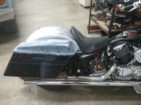 1995 Ford F-150 - A motorcycle's side profile shows its saddlebags, seat, engine, and exhaust system.