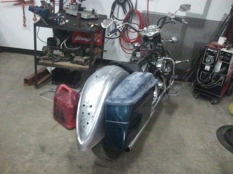 1995 Ford F-150 - Motorcycle undergoing customization in a workshop environment, with tools and equipment visible.