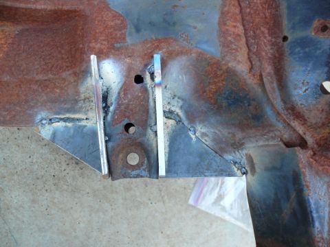1976 Chevrolet Corvette - Close-up of a rusted metal frame section showing recent welding work.
