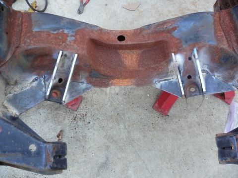 1976 Chevrolet Corvette - A heavily rusted section of a vehicle frame has been reinforced with welded metal plates.