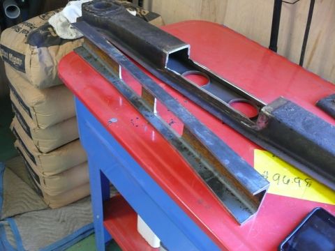 1976 Chevrolet Corvette - Metal components are laid out on a red workbench, with a yellow price tag visible.