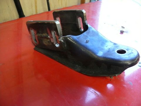 1976 Chevrolet Corvette - A metal bracket part is shown on a red surface, with the "Supermotors.net" logo visible at the bottom right.