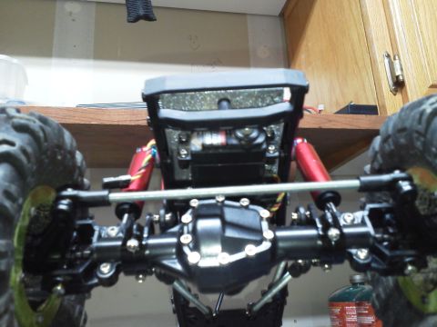 1985 Ford Bronco - The front suspension and differential of a remote control rock crawler are visible in this close-up shot.