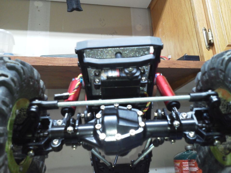 Remote control rock crawler chassis front view with exposed suspension and differential