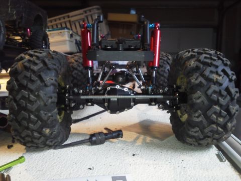 1985 Ford Bronco - Close-up of a remote-controlled rock crawler's rear suspension and drivetrain components.