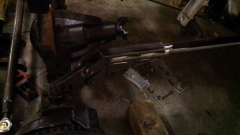 1967 Ford F-250 - Close-up view of a rear axle assembly and driveshaft, with various tools scattered on the floor.