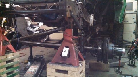 1967 Ford F-250 - Under construction: vehicle frame and suspension components are held up by jack stands.