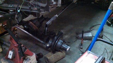1967 Ford F-250 - The front axle and steering components of a truck are visible, undergoing maintenance or modification.