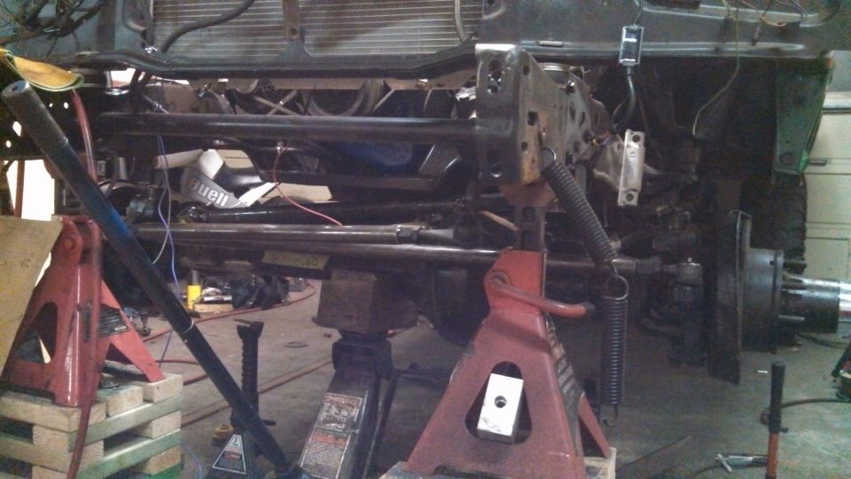 Truck chassis on jack stands, showing suspension and frame components