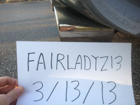 1996 Ford Bronco - A piece of paper with writing is held in front of a chrome exhaust tip.