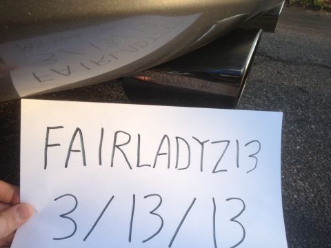 1996 Ford Bronco - A handwritten sign with identifying text is placed near the exhaust of a vehicle.