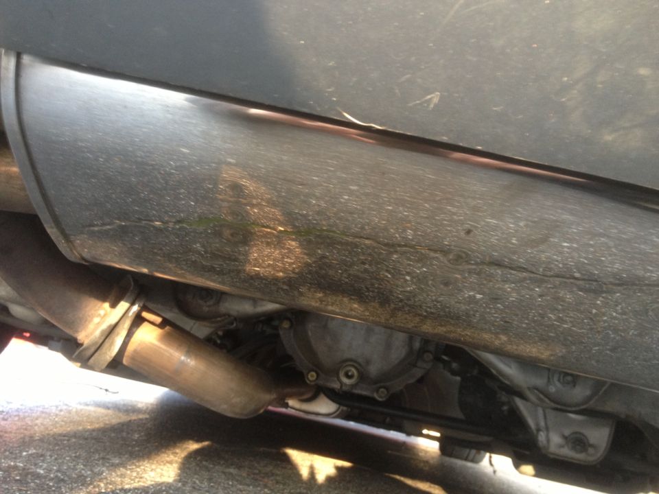Underside of a vehicle showing exhaust pipe and rear differential