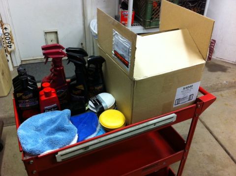 2010 Dodge Challenger - A red cart holds various car cleaning products and a cardboard box, ready for detailing.