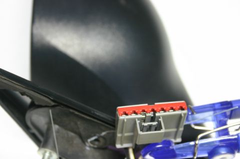 2000 Dodge Neon - Close-up view of a car mirror's electrical connector, showing the red and gray housing.
