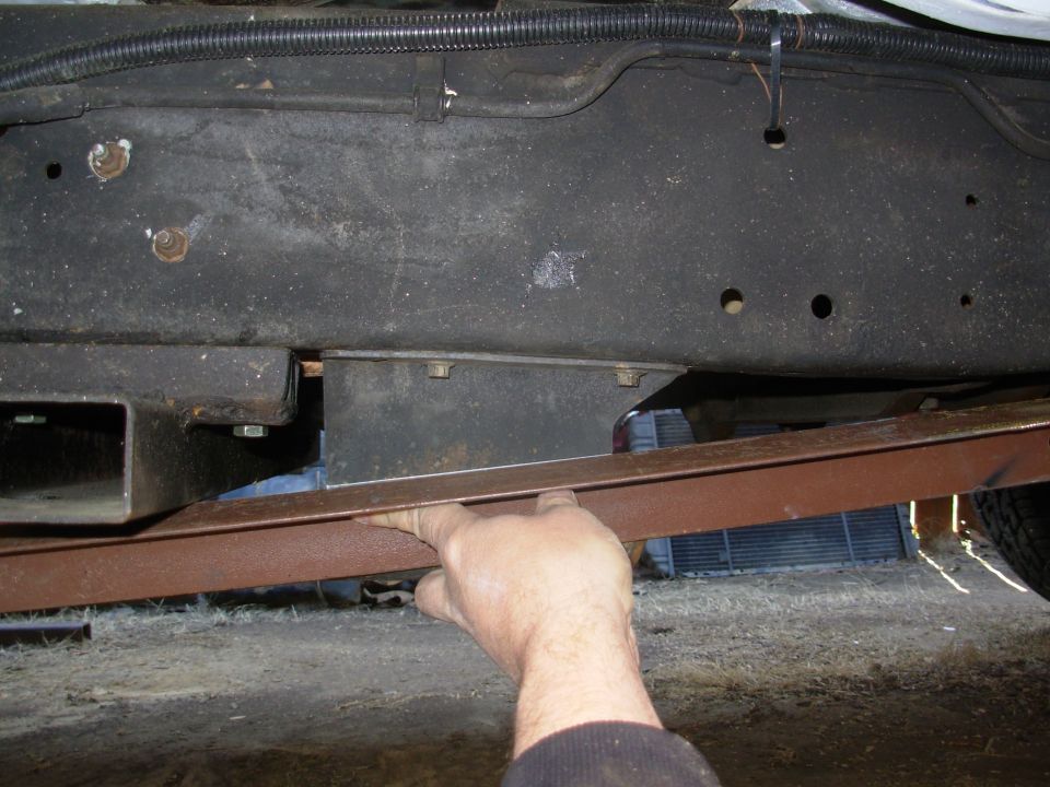With the clocked t-case, this skidplate is almost worthless, so I'm using its legs to mount my fabricated skidplate, which will run between the trans Xmbr (out of frame R) & my battery Xmbr (Left).  I'm cutting along these lines.

The split loom at the top of the pic is the aux.batt. cable.