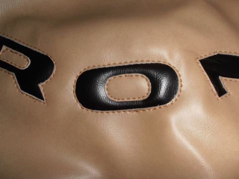 1990 Ford Bronco - Close-up of the stitched lettering on a tan tire cover.