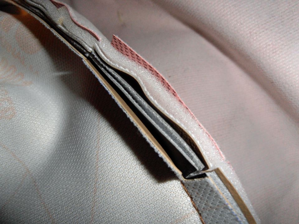 Close-up of a tire cover edge with layered material