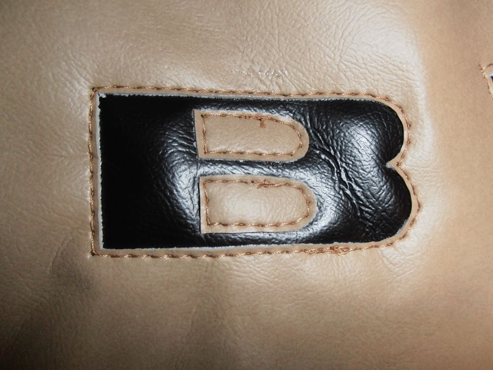 tan material with black and tan applique letter B