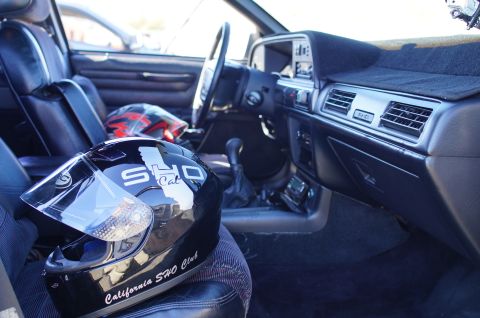 1995 Ford Taurus - Interior view of a car, showing a black helmet with 'California SHO Club' text and a red helmet on the seats.