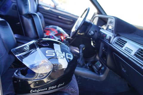 1995 Ford Taurus - The interior of a car, a black helmet with 'California SHO Club' text and another helmet on the passenger seat.