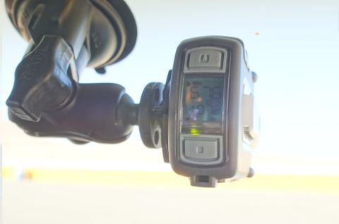 1995 Ford Taurus - A close-up of an electronic device with a digital display, mounted inside a vehicle.