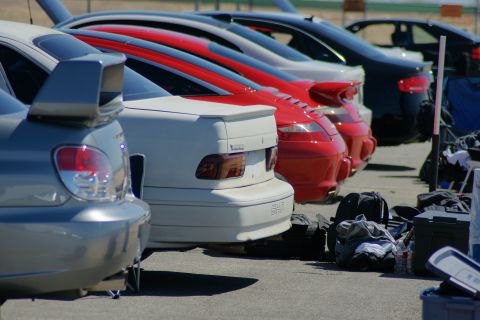 1995 Ford Taurus - Multiple vehicles lined up, with personal items and equipment scattered nearby.