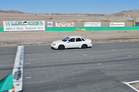 1995 Ford Taurus - White 1995 Ford Taurus sedan on the track at Willow Springs International Raceway.