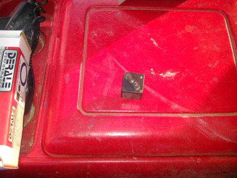 1979 Ford Bronco - A close-up view of an electric relay and a product box on a red surface.