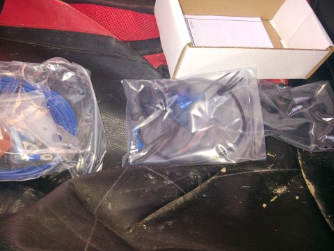 1979 Ford Bronco - Various automotive parts are packaged in plastic bags and placed on the seats of a vehicle.