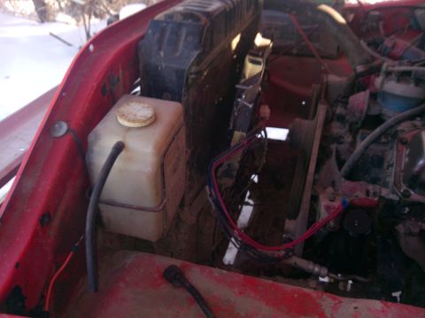 1979 Ford Bronco - View of the engine bay, showing the coolant reservoir and fan assembly.