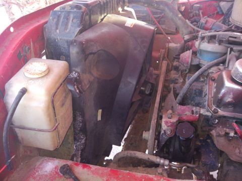 1979 Ford Bronco - Close-up view of the engine bay, focusing on the fan shroud and coolant reservoir.