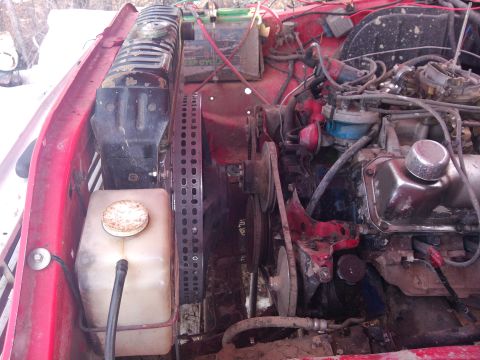 1979 Ford Bronco - Close-up view of the engine compartment, showing various mechanical parts and wiring.