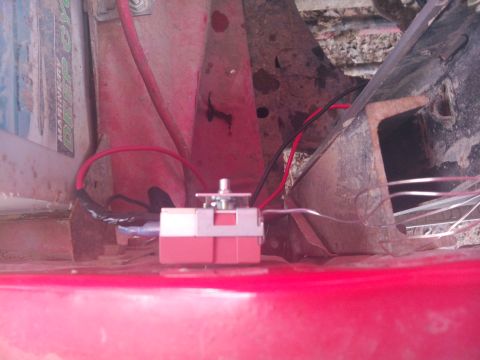 1979 Ford Bronco - Close-up of automotive electrical components, including a red relay and wiring.
