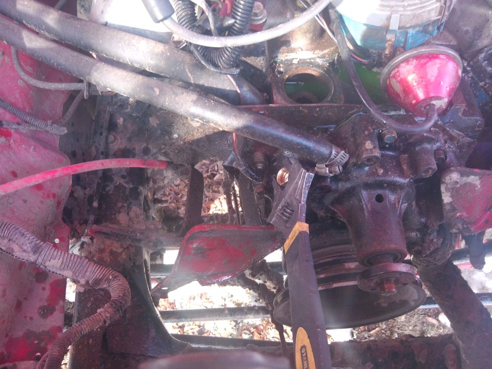Engine bay with adjustable wrench on a hose clamp