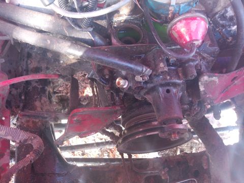 1979 Ford Bronco - Close-up of an engine part, likely a water pump or similar component, with visible wear and corrosion.