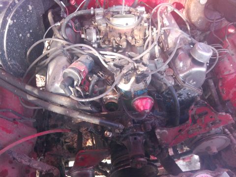 1979 Ford Bronco - Close-up view of a vehicle's engine compartment, showing various mechanical components.