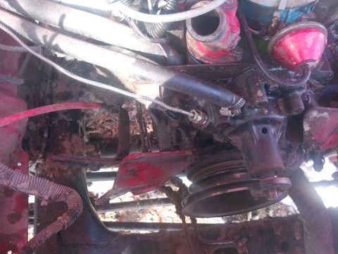 1979 Ford Bronco - Close-up view of engine components, including a pulley and hoses.
