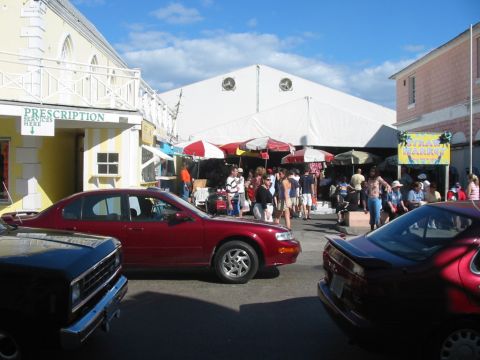 1992 Ford Bronco - A street scene with several vehicles and a bustling market under a large white tent.