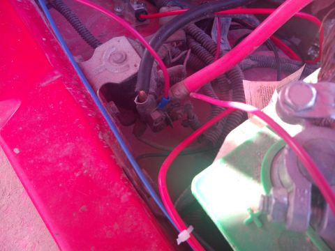 1979 Ford Bronco - Close-up view of the battery wiring and connections in a vehicle's engine bay.