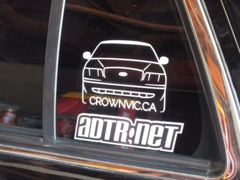 2003 Ford Crown Victoria - Vinyl decals reading CrownVic.ca with a sedan outline and ADTR.net logo applied to a tinted rear side window