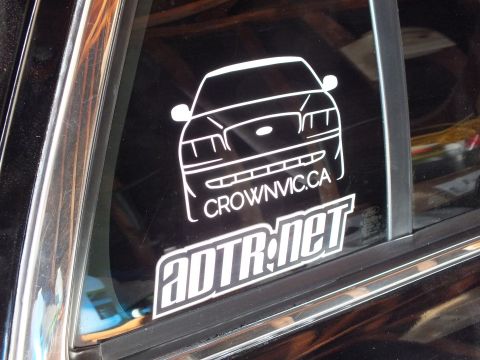 2003 Ford Crown Victoria - Detailed white CrownVic.ca sedan-front outline decal above the ADTR.net logo on a dark vehicle window