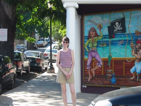 1992 Ford Bronco - Street scene with a woman, parked cars, and a colorful pirate mural on a building.
