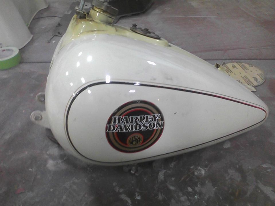 White Harley Davidson motorcycle gas tank with black and red pinstripes and circular logo