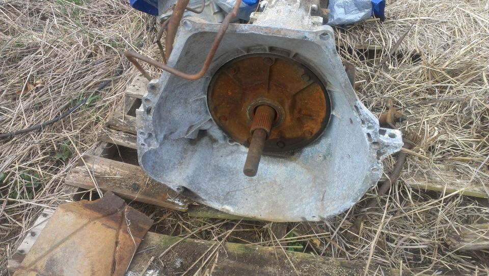 rusted automatic transmission part with torque converter visible