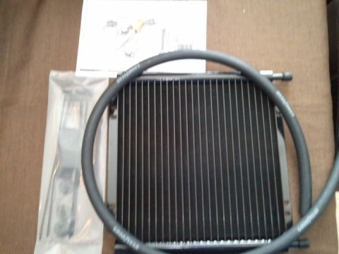 1994 Ford Bronco - A new radiator and hose assembly, along with installation instructions and hardware, are laid out on a surface.